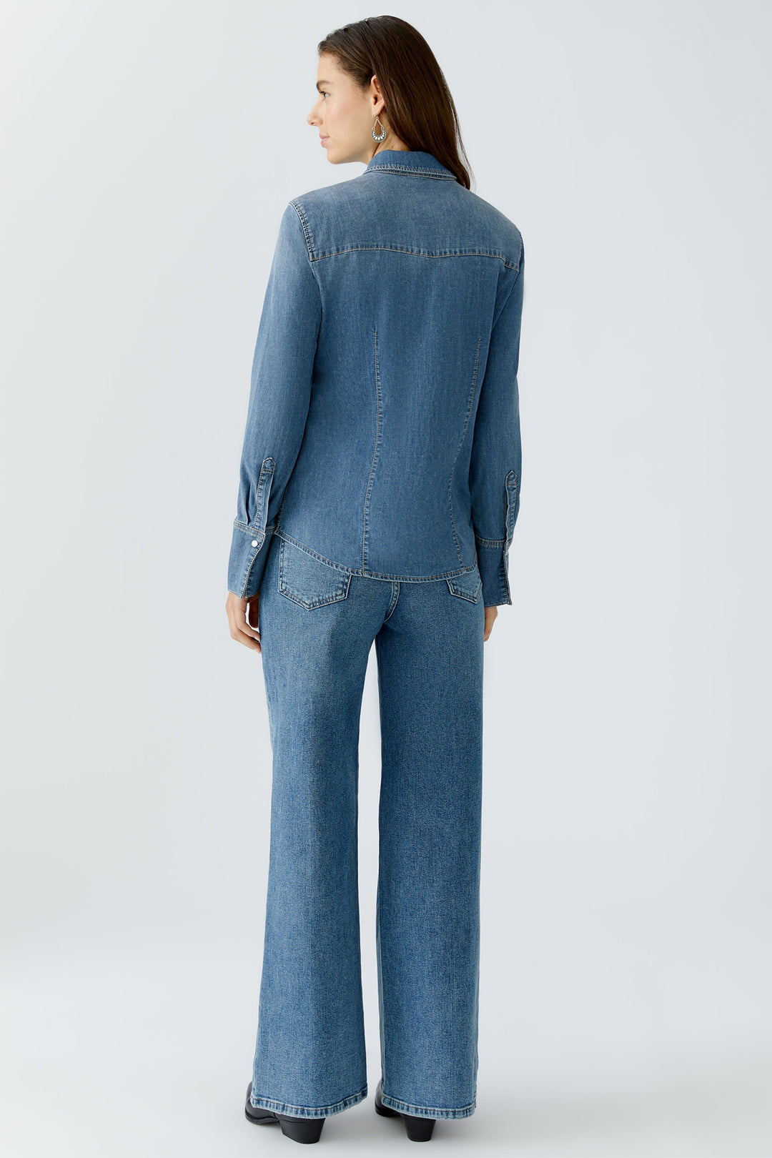 Woman wearing a denim outfit on a white background