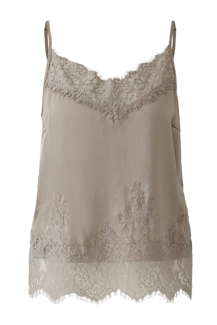 Beige lace-trimmed top on a white background