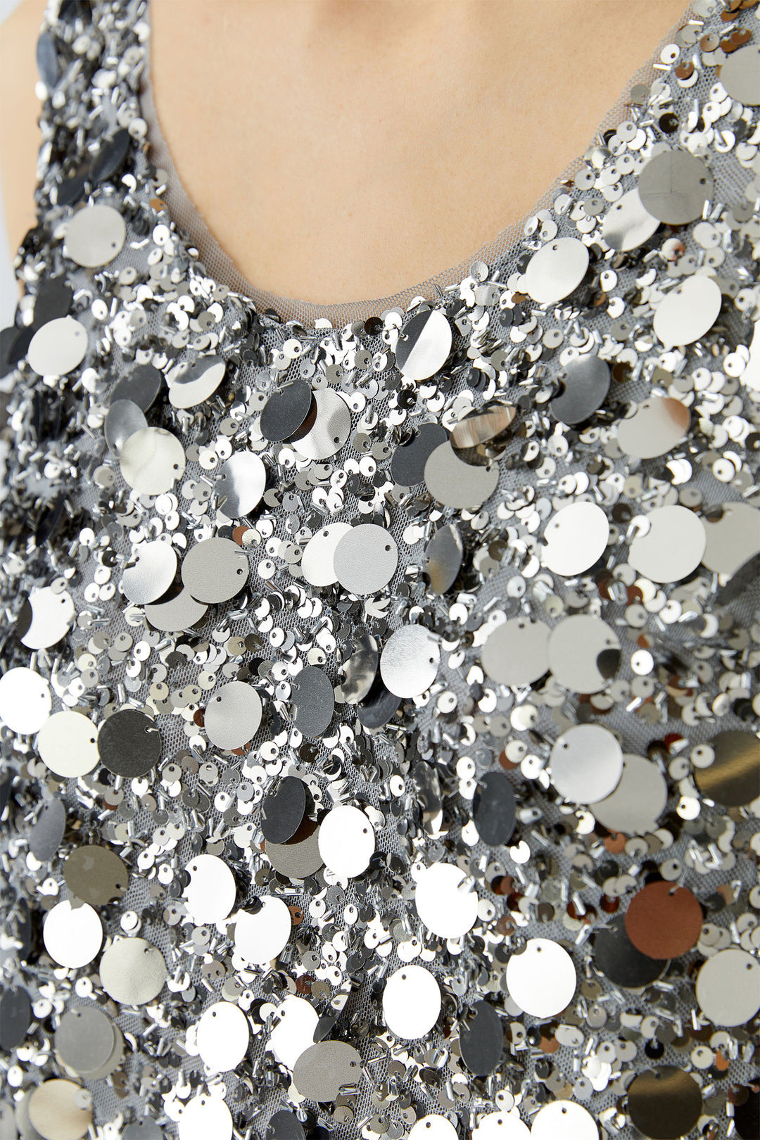 Close-up of a silver sequin fabric with a blurred background
