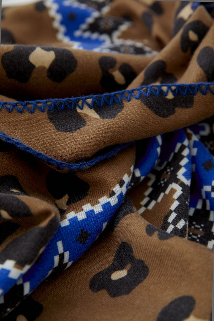Close-up of patterned fabric with brown, blue, and black colors.