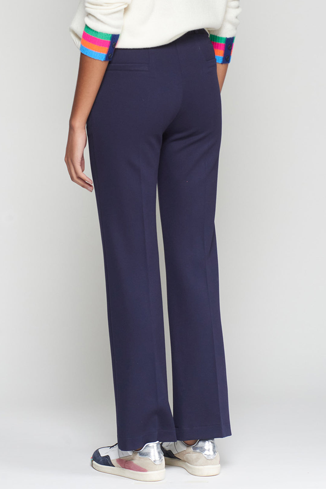 Navy blue pants worn by a person on a white background