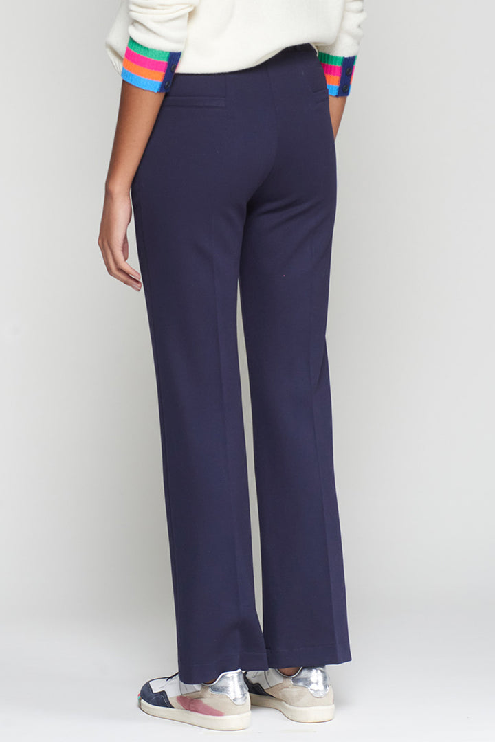 Navy blue pants worn by a person on a white background