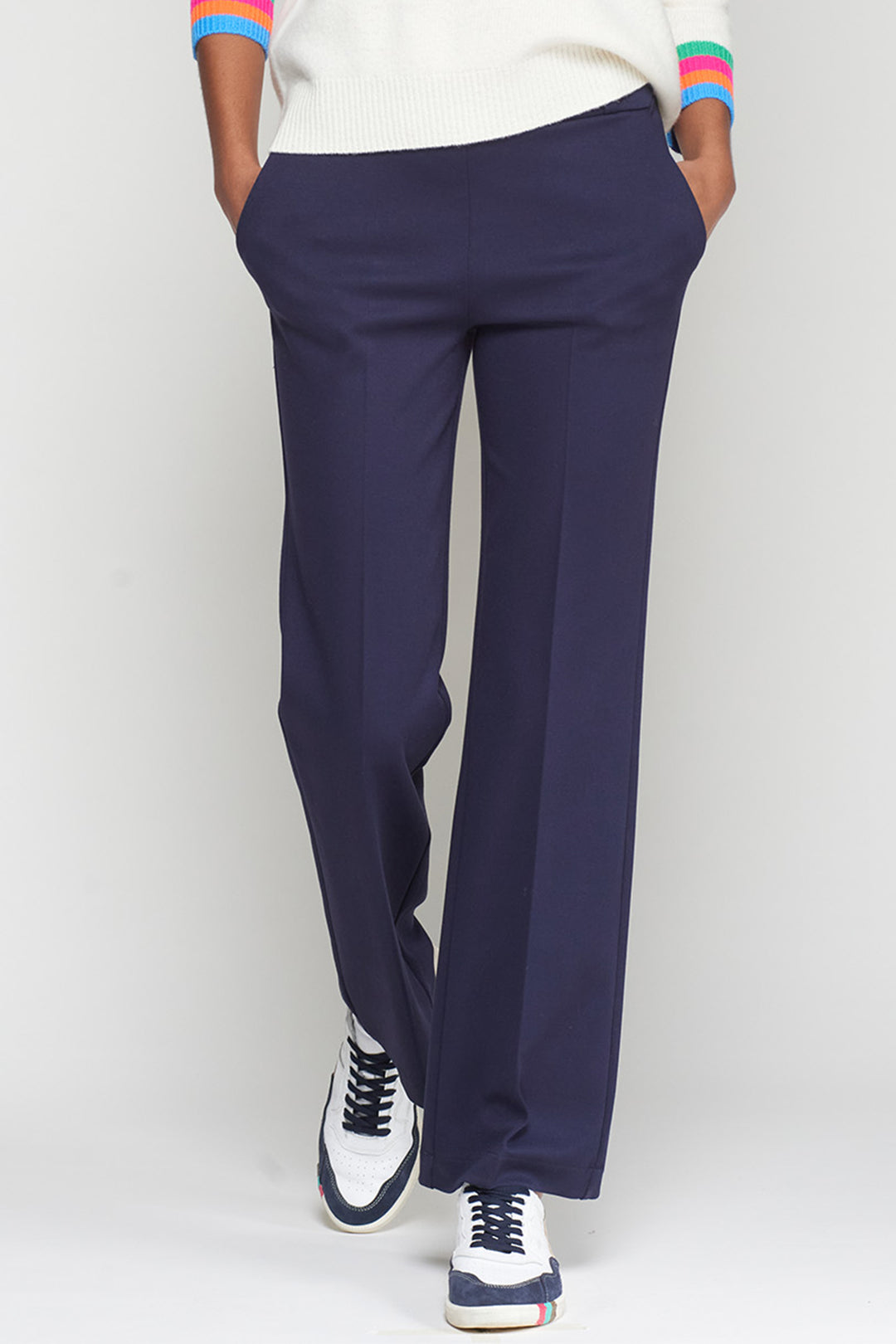 Navy blue pants worn by a person on a white background