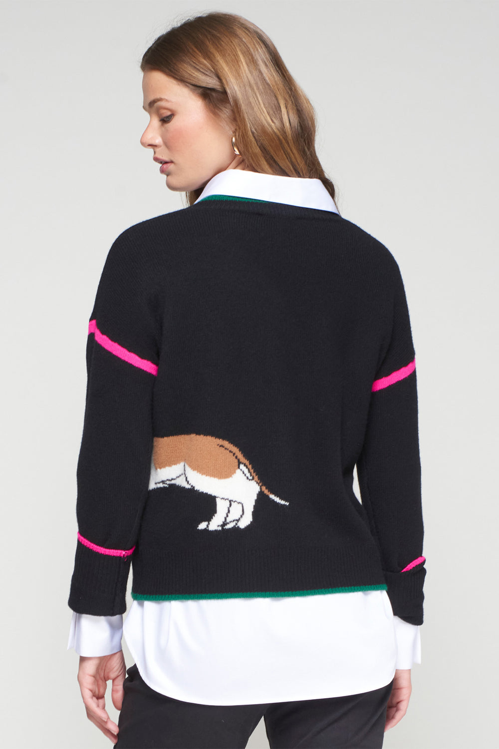 Woman wearing a black sweater with a horse design on a white background
