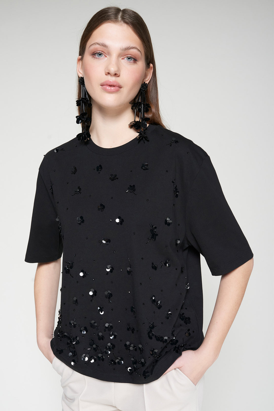Woman wearing a black t-shirt with star patterns on a white background