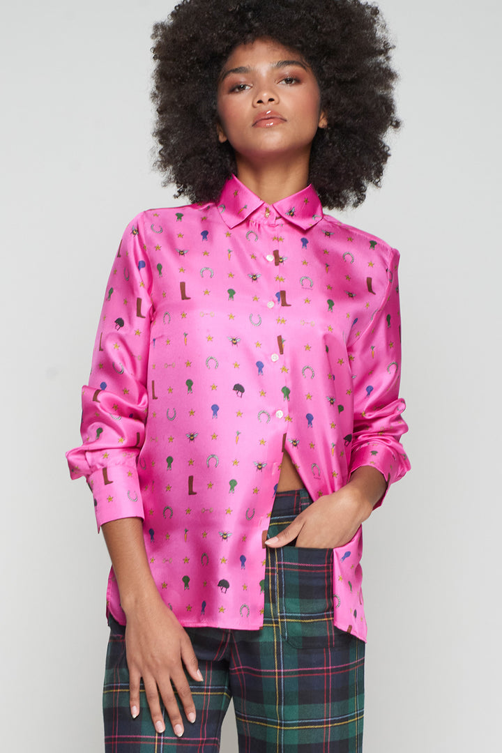 Person wearing a pink patterned shirt with plaid pants on a plain background