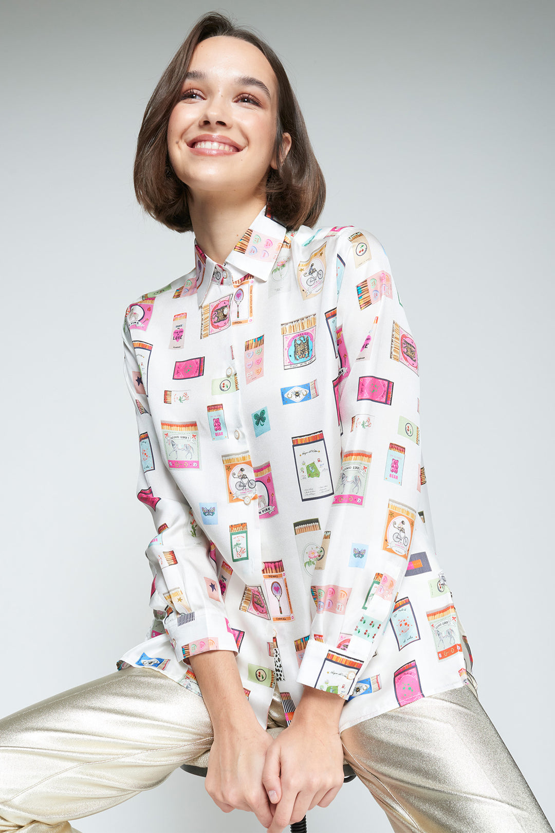 Woman wearing a patterned blouse with a plain background
