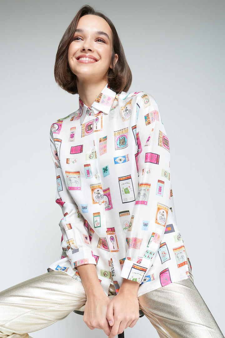 Woman wearing a patterned blouse with a plain background