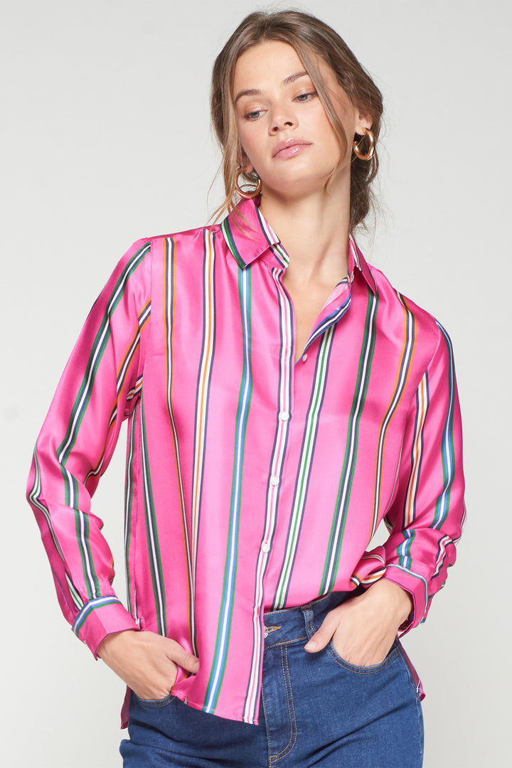 Woman wearing a pink striped shirt with a plain background