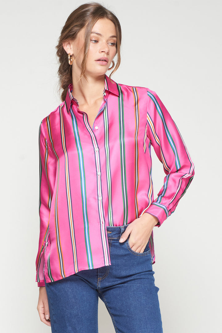 Woman wearing a pink striped shirt with a plain background