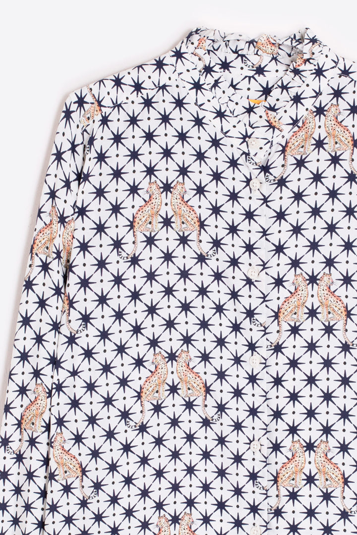 Shirt with a pattern of stars and abstract shapes on a white background