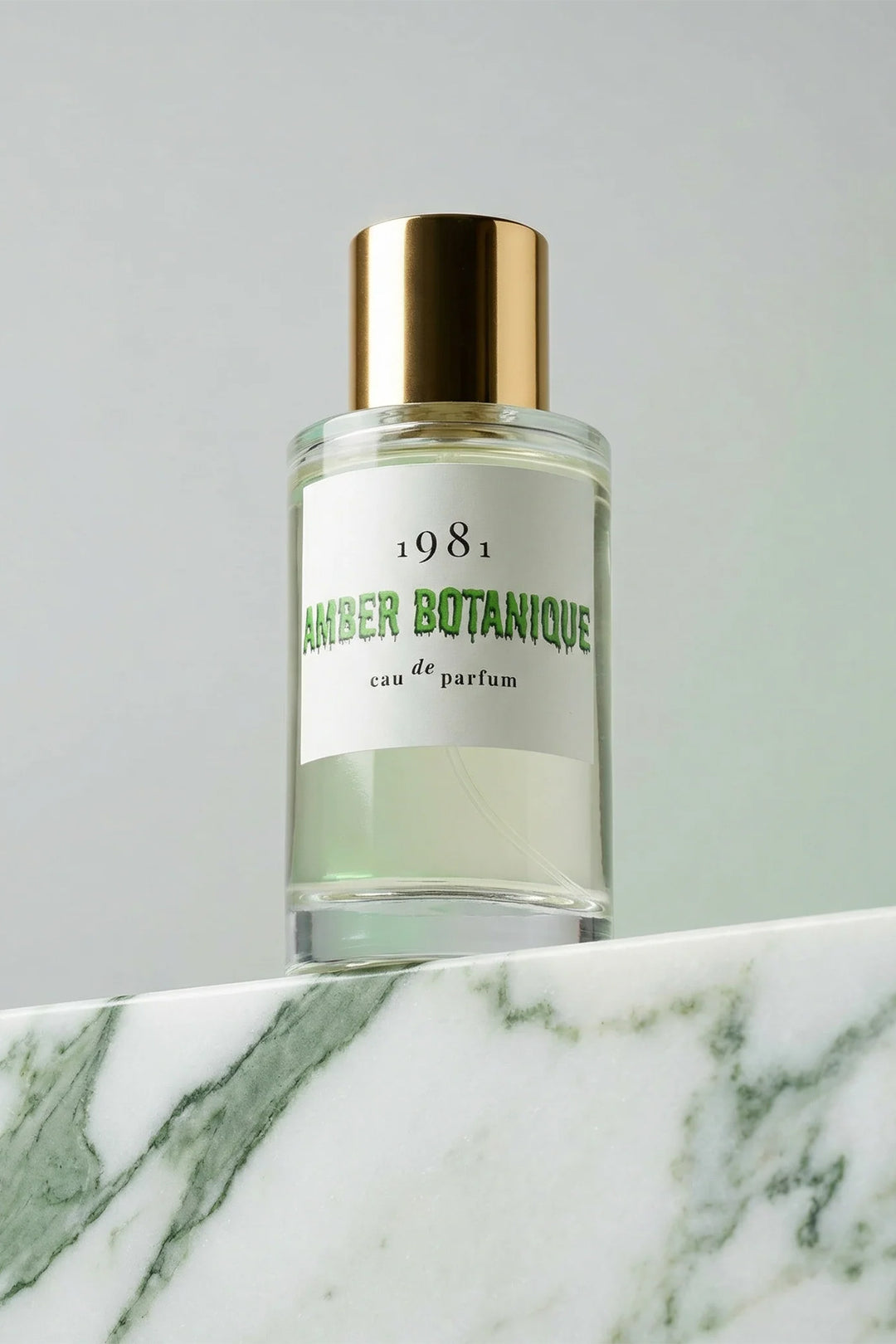 1981 Fragrance Amber Botanique Eau De Parfum 100ml, bottle front on green marble