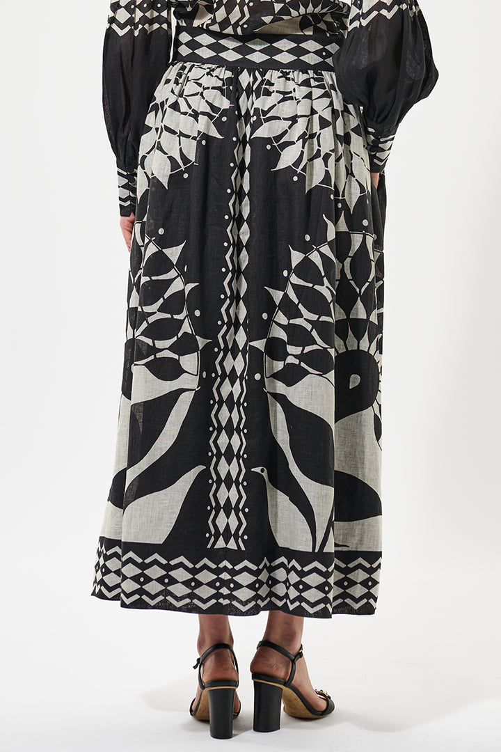 Person wearing a black and white patterned dress on a white background