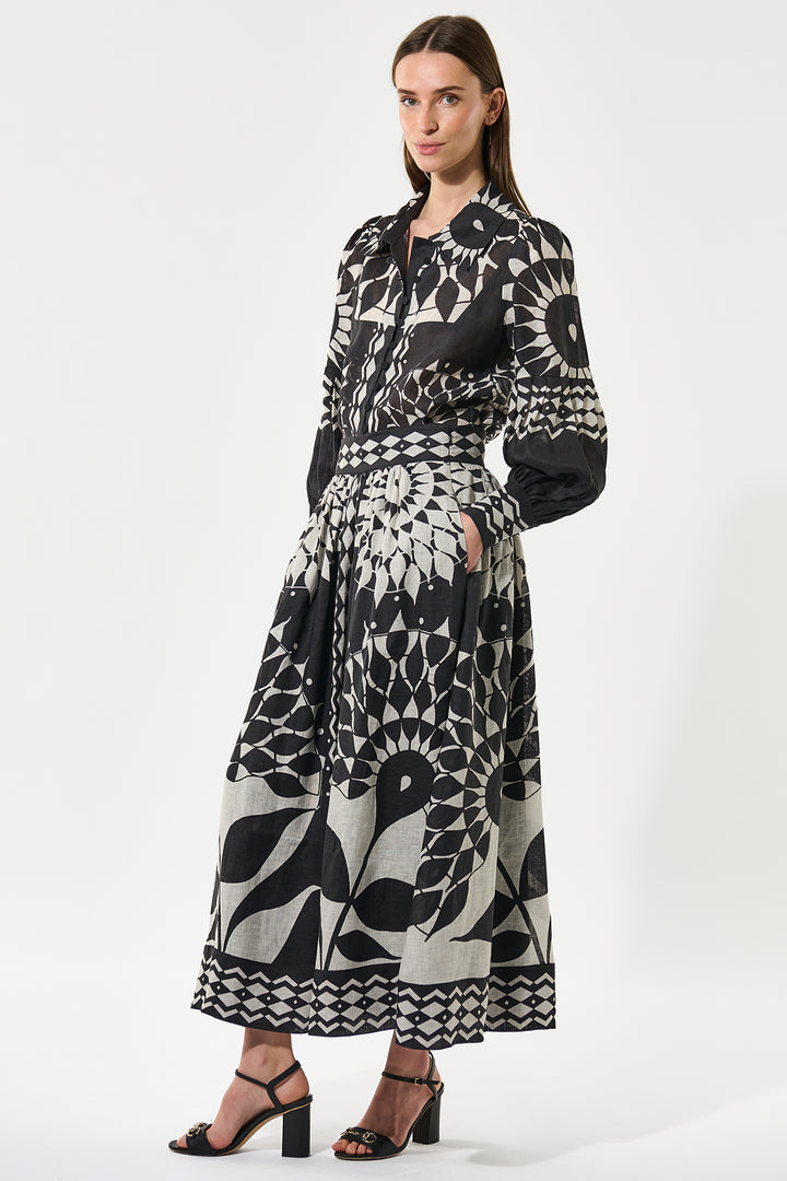 Woman wearing a black and white patterned dress on a white background