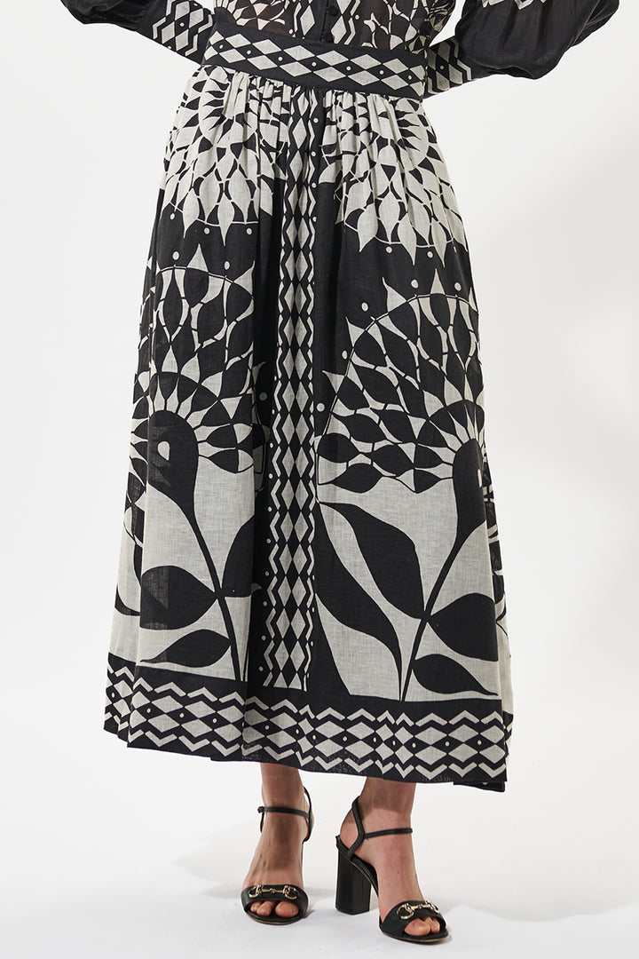 Person wearing a black and white patterned outfit on a white background