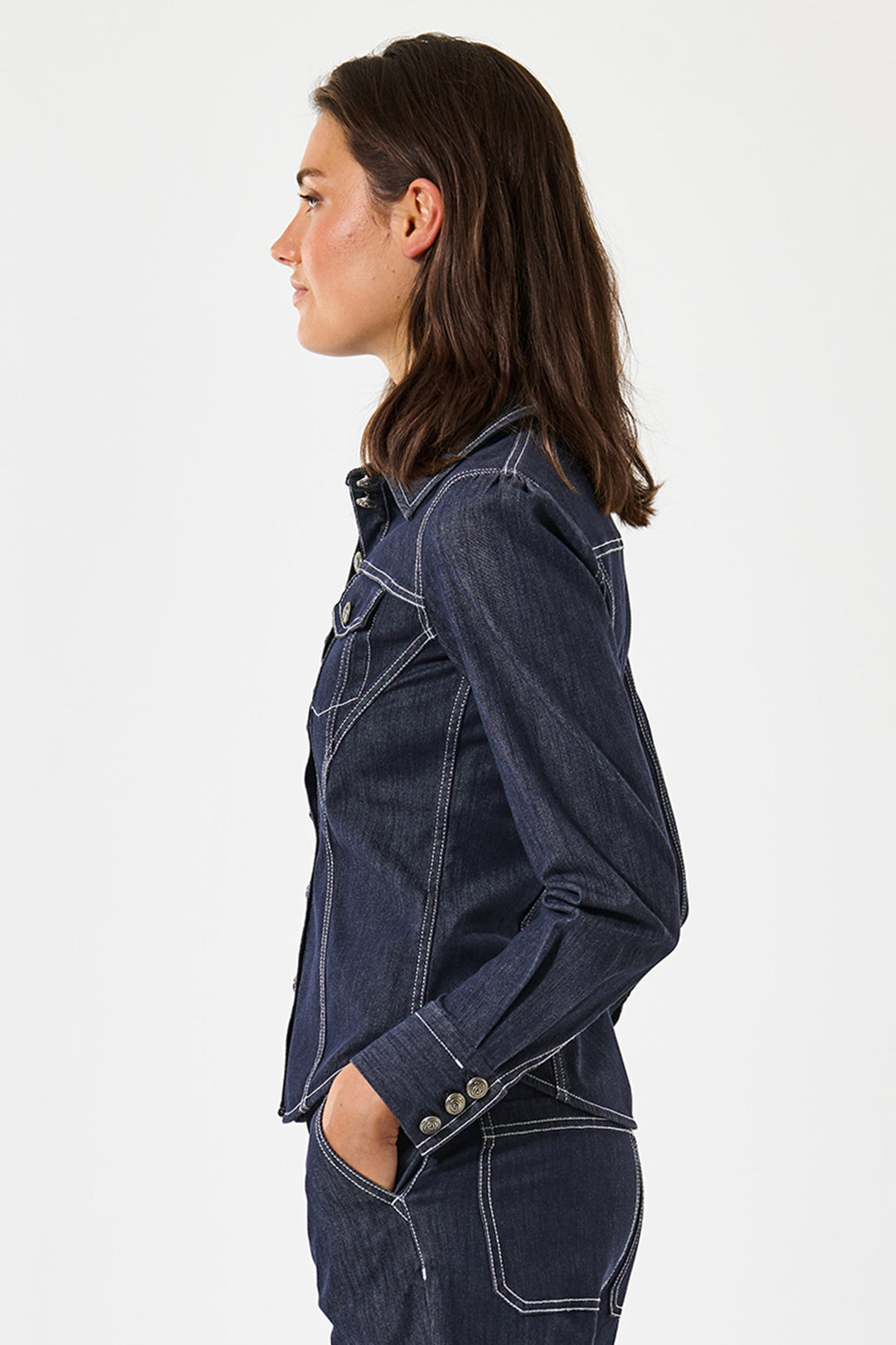 Woman wearing a dark blue denim jacket on a white background