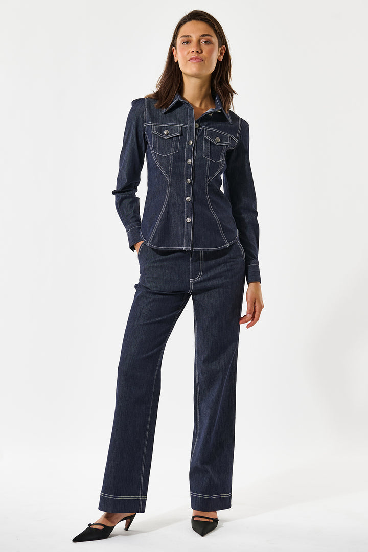 Woman wearing a dark blue denim outfit on a white background