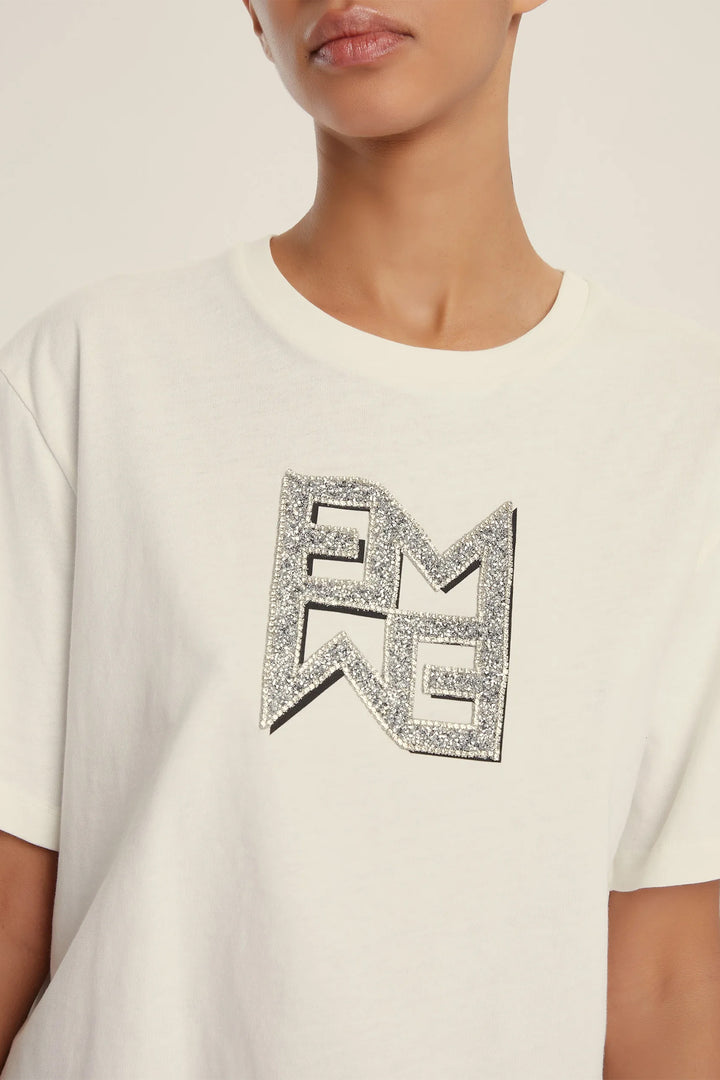 White t-shirt with a decorative logo on a neutral background
