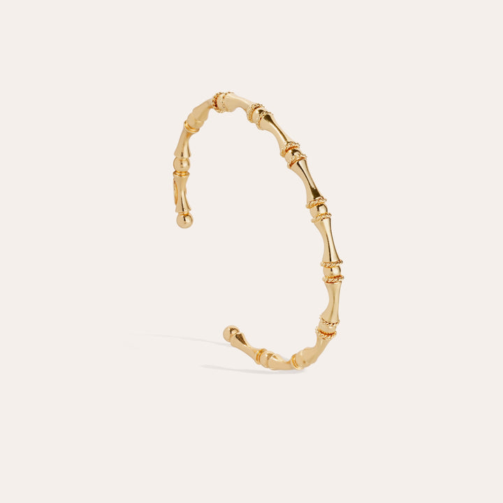 Gold bracelet on a light beige background