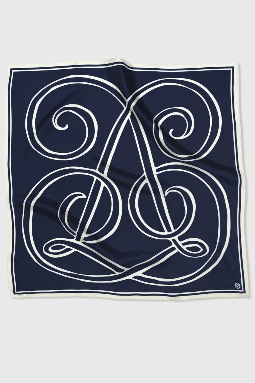 Navy blue square scarf with white intricate design on a light gray background