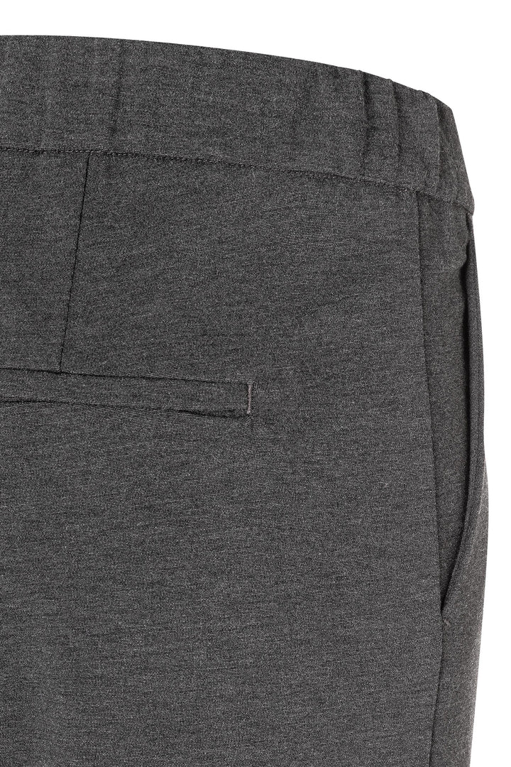 Close-up of gray pants with a pocket on a white background