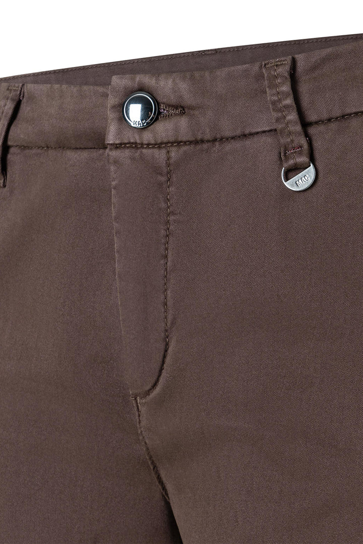 Close-up of brown pants with button and zipper details
