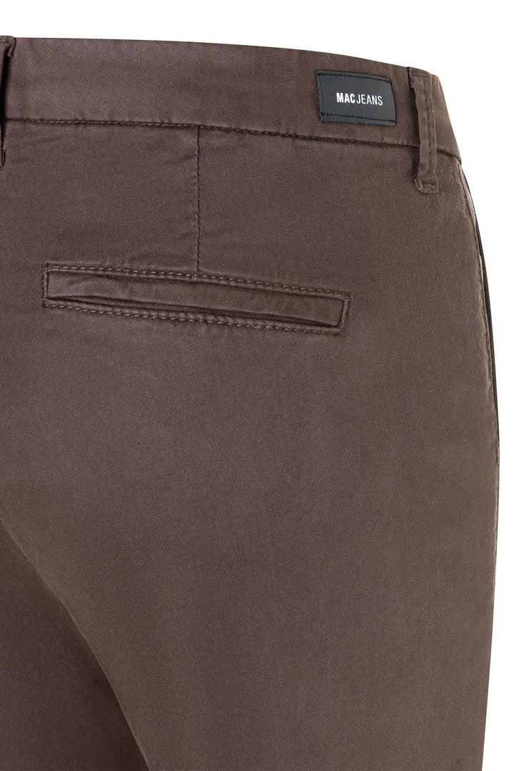 Brown pants with a visible MAC JEANS label on a white background