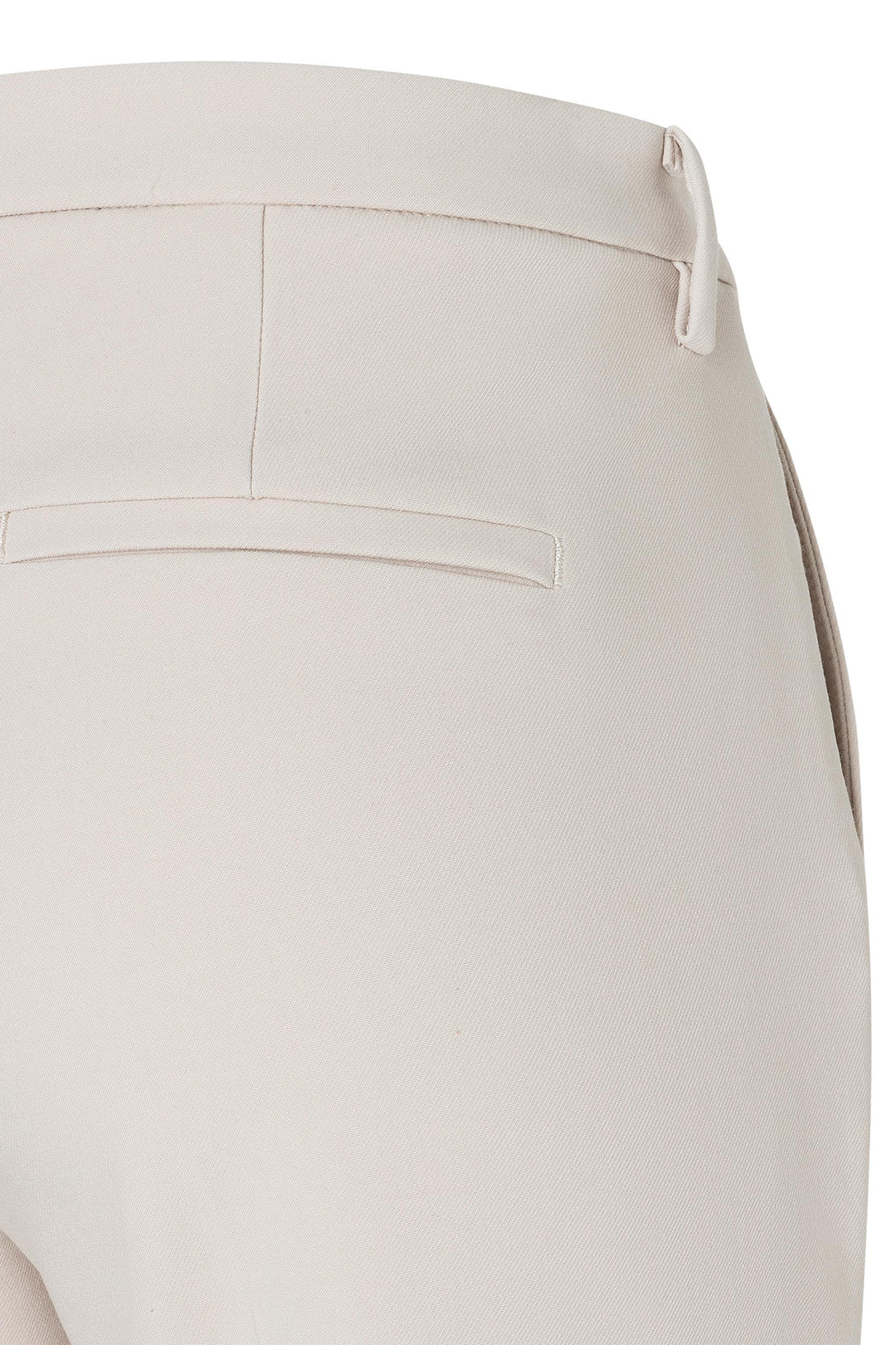 Close-up of beige pants with a white background