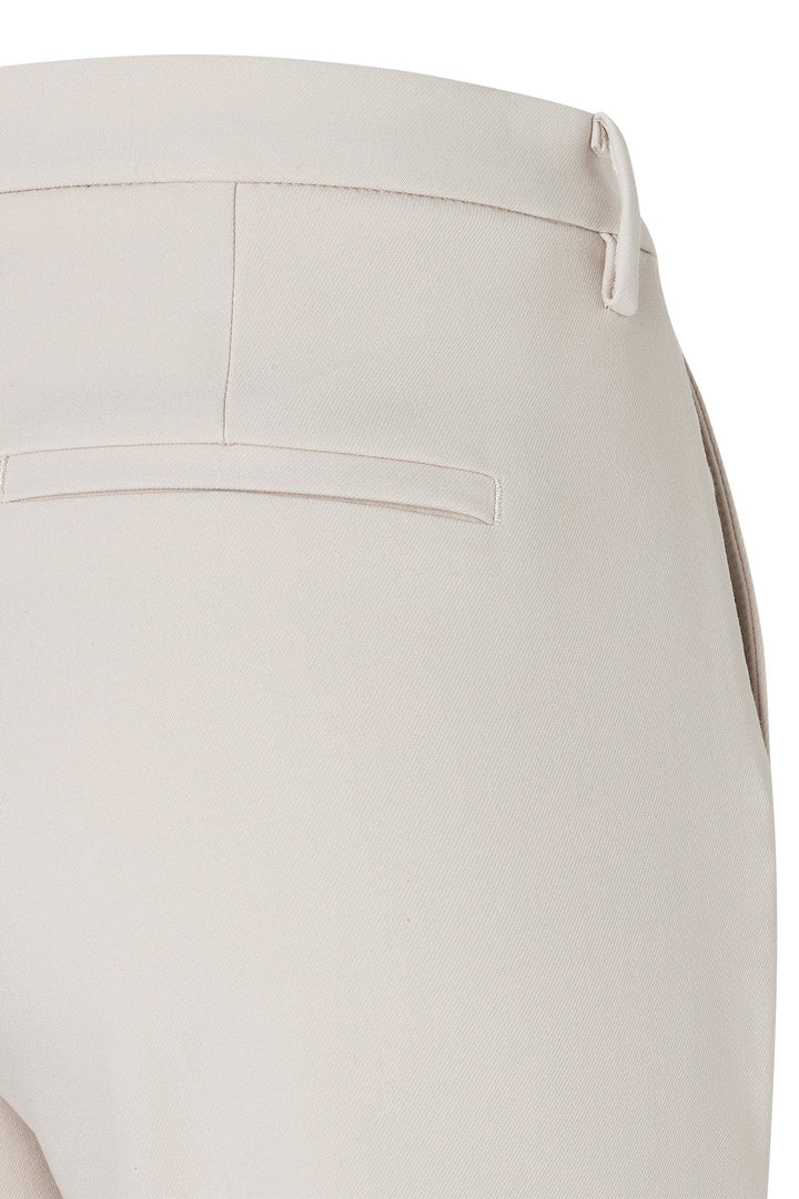 Close-up of beige pants with a white background