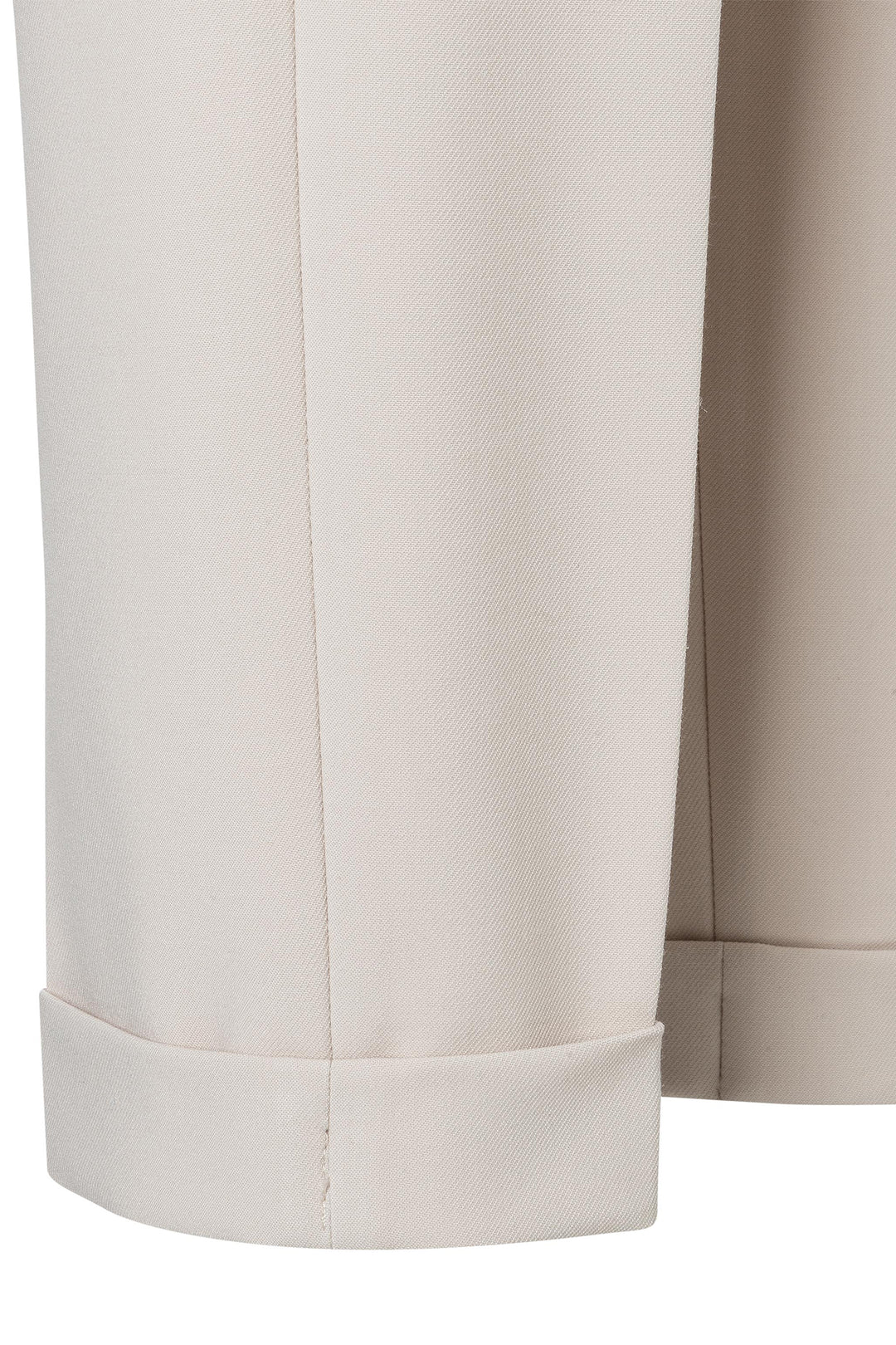 Close-up of beige pants with a white background