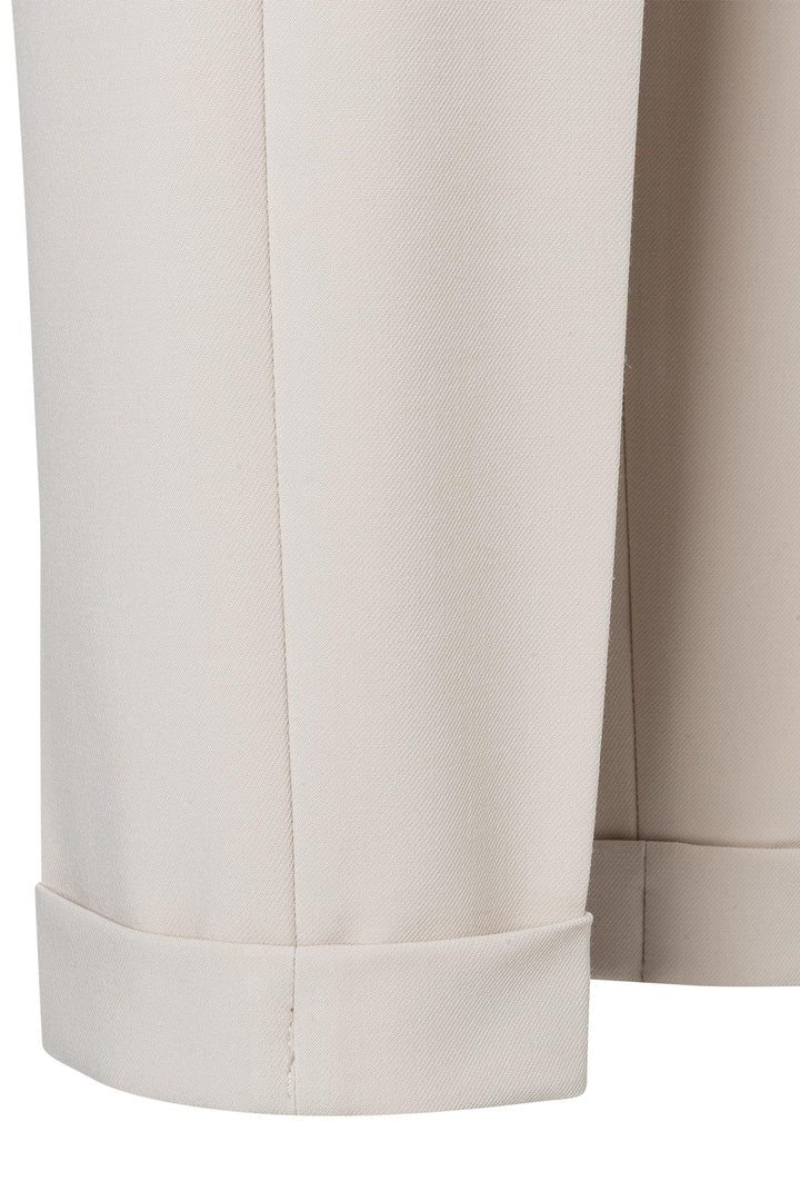 Close-up of beige pants with a white background
