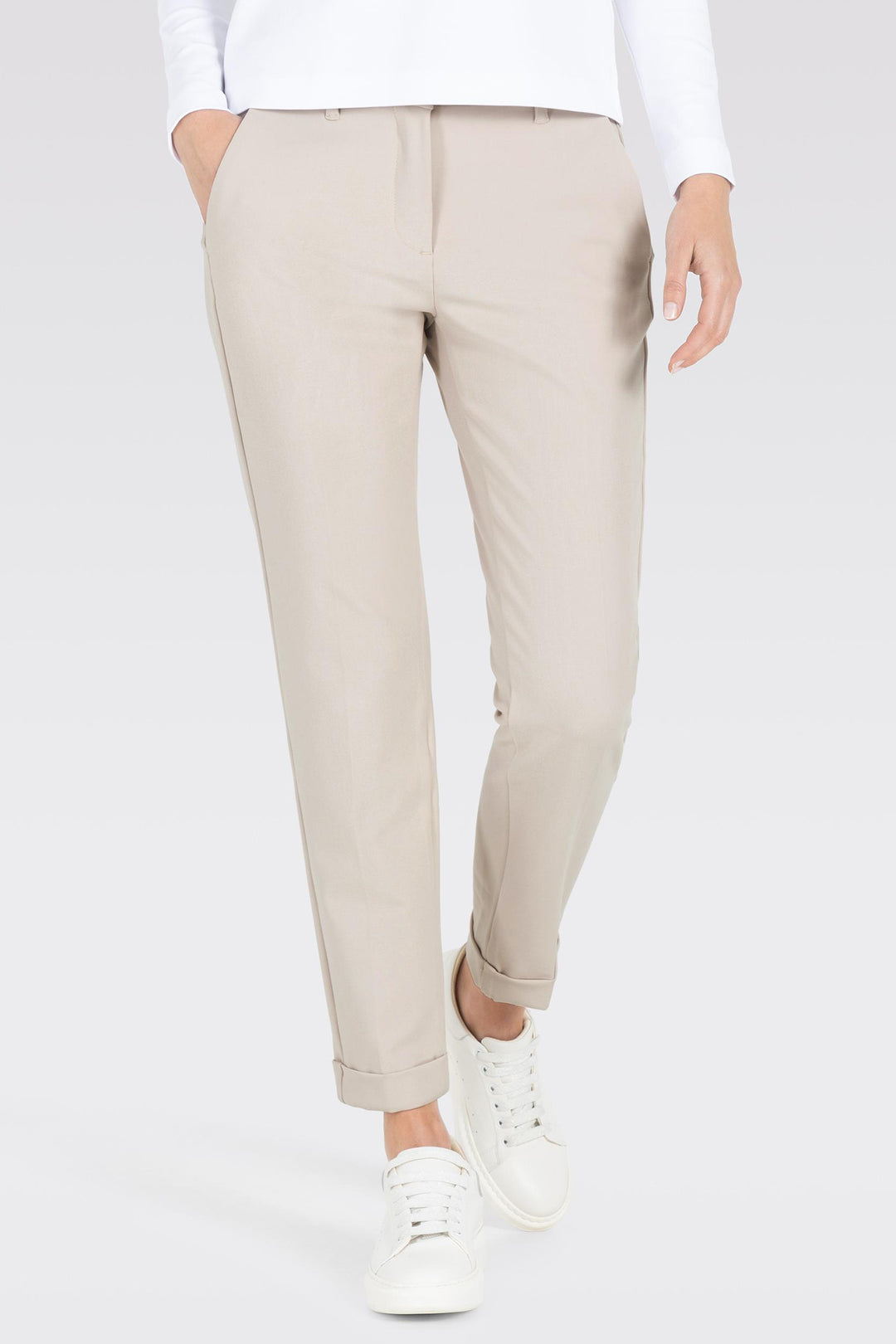 Beige pants worn by a person on a white background