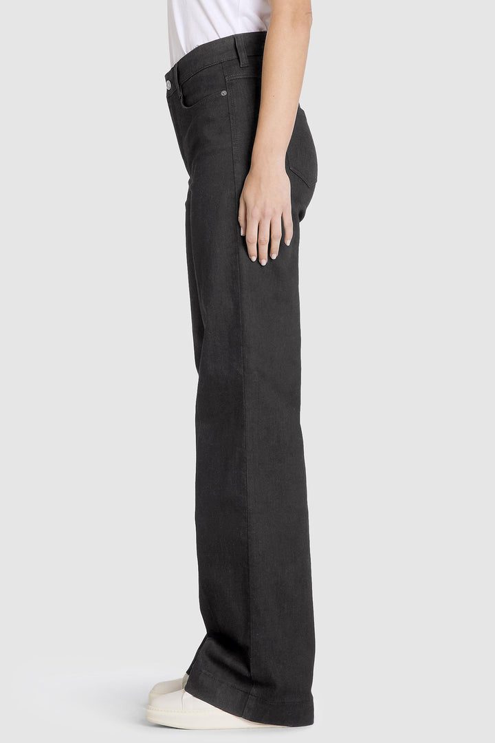 Person wearing black jeans on a white background