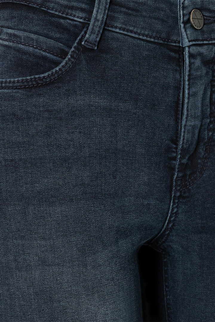 Close-up of dark blue denim fabric with stitching details