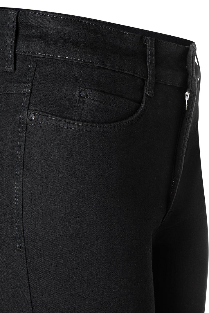 Close-up of black pants with a focus on the waistband and pocket area.