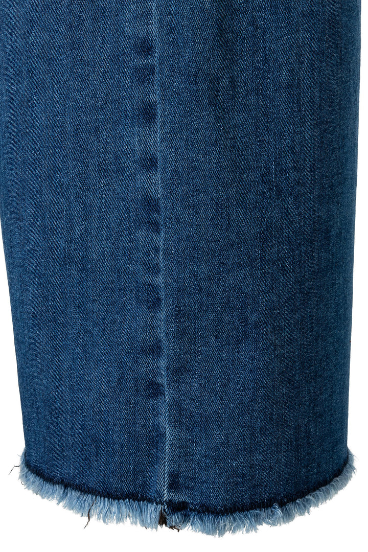 Close-up of a blue denim skirt with frayed hem on a white background
