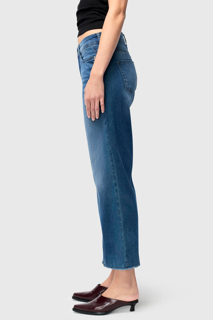 Person wearing blue jeans on a white background