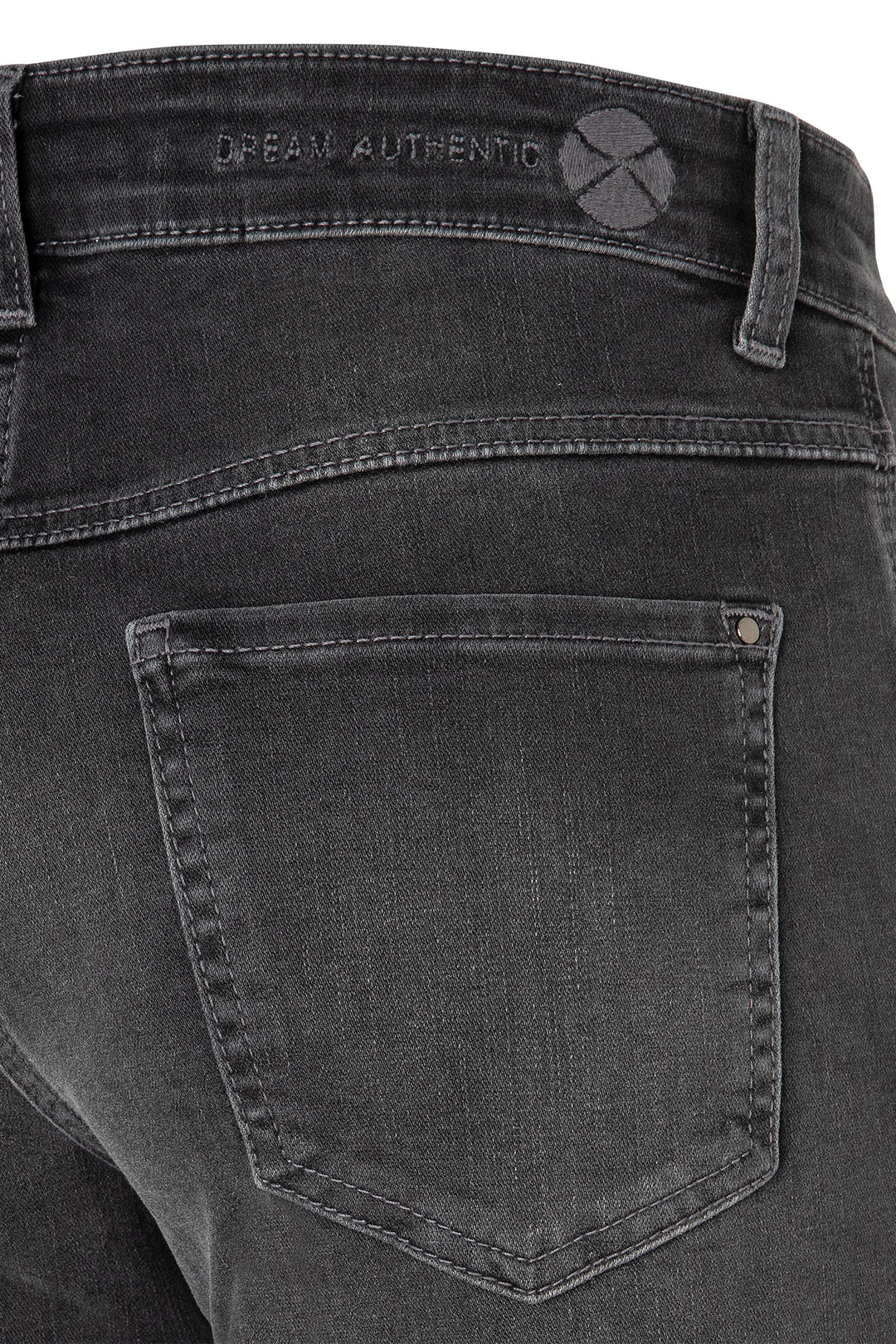 Close-up of black jeans with a brand logo on the back pocket.