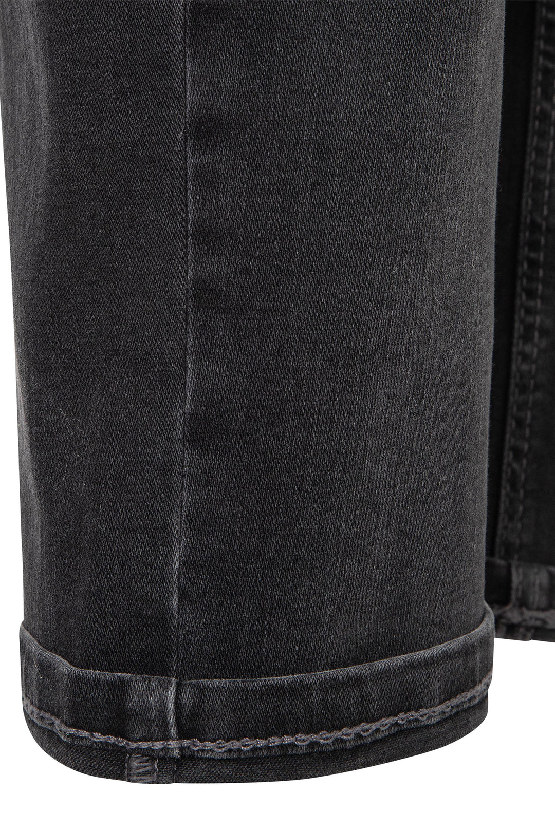 Close-up of black denim shorts with visible stitching on a white background