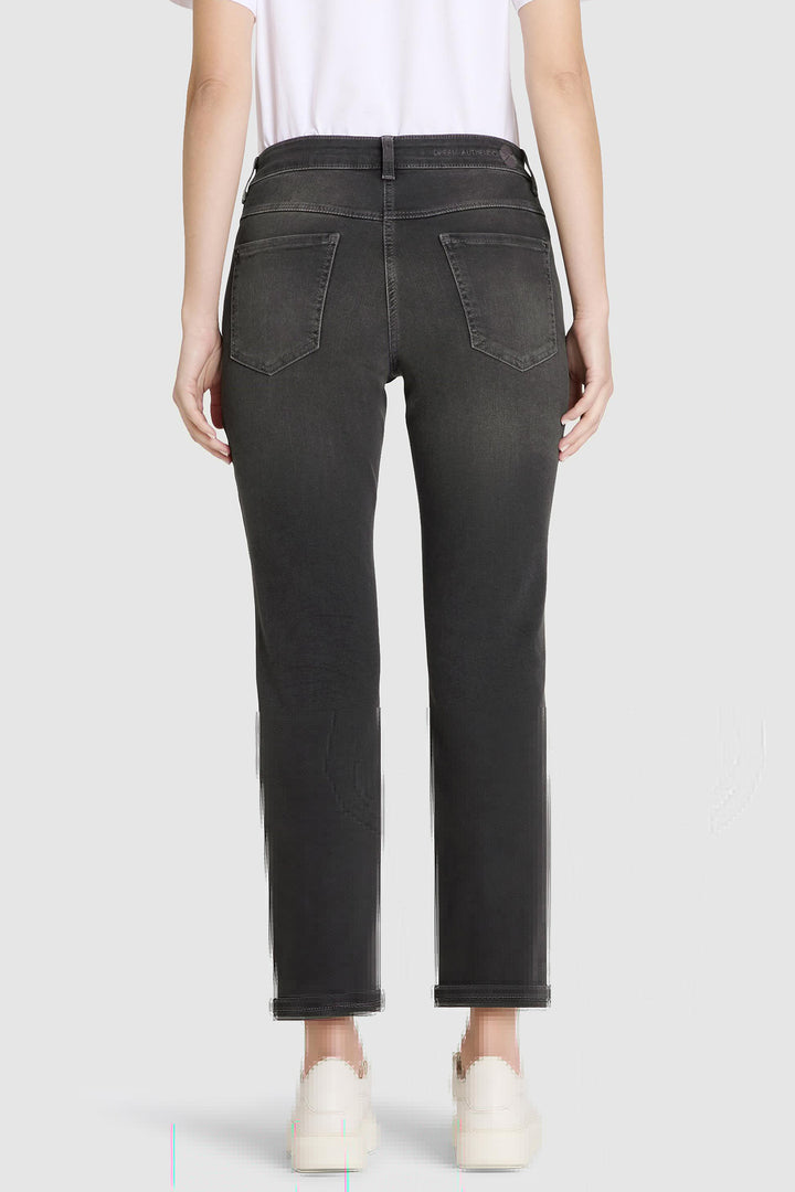Person wearing black jeans on a white background