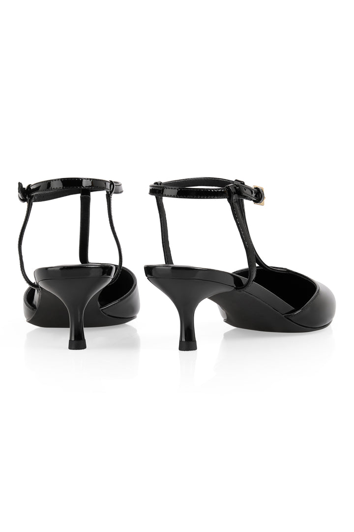 Black high-heeled shoes with thin straps on a white background