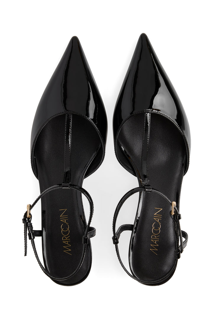 Black patent leather high heels with 'Marciano' branding on a white background