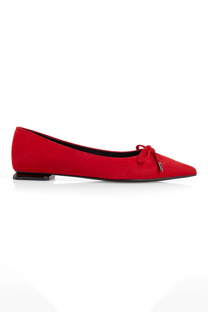Red flat shoe with a bow on a white background