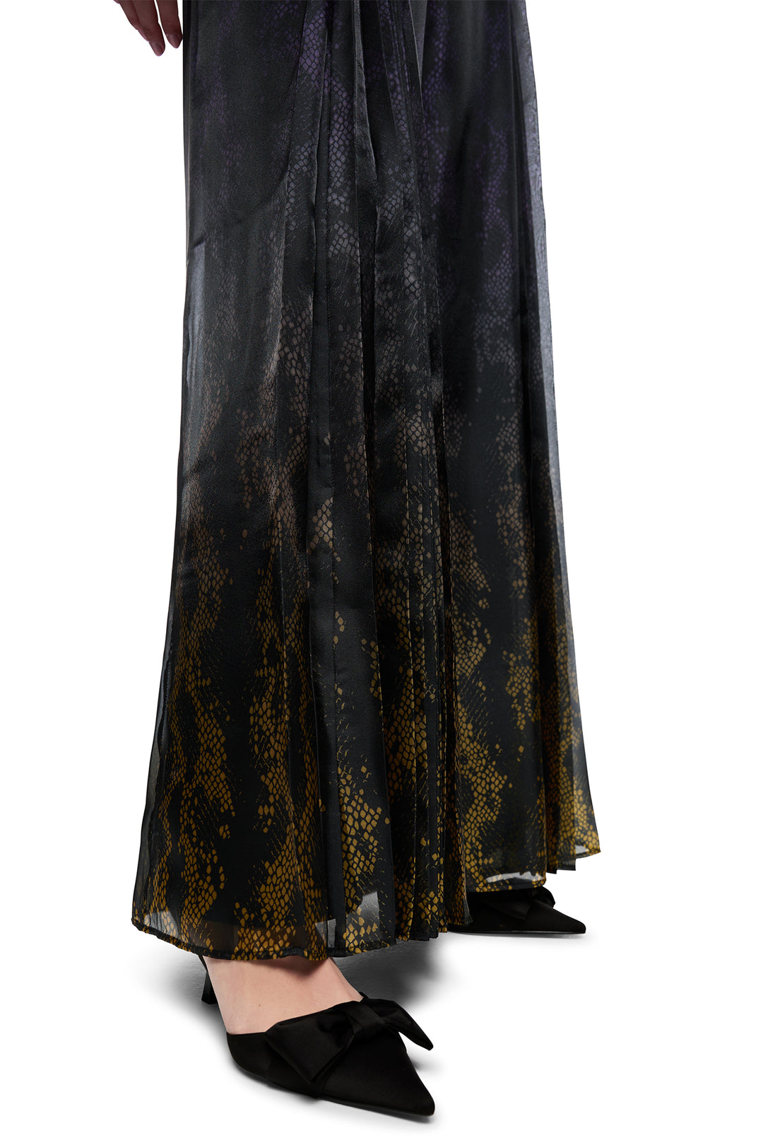 Black lace dress with gold accents on a white background