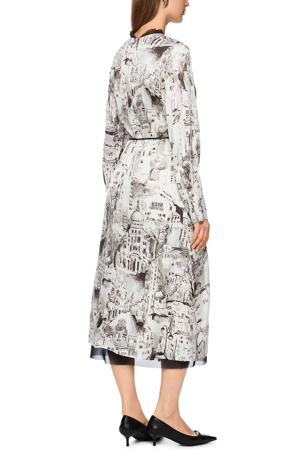 Woman wearing a long, patterned dress on a white background
