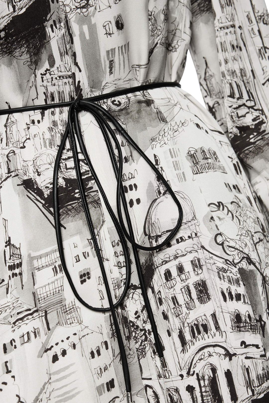 Black-framed eyeglasses on a patterned fabric background