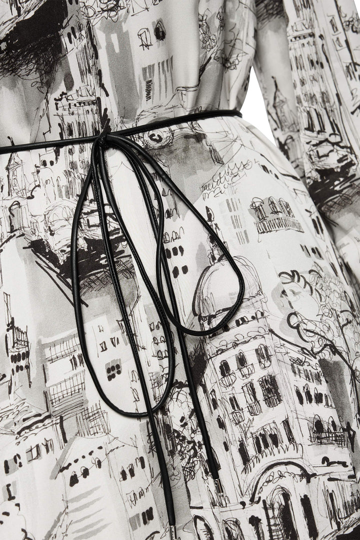 Black-framed eyeglasses on a patterned fabric background