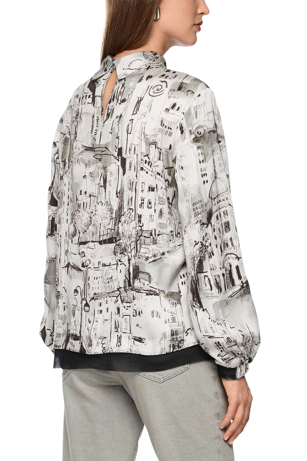 Woman wearing a patterned blouse with a white background