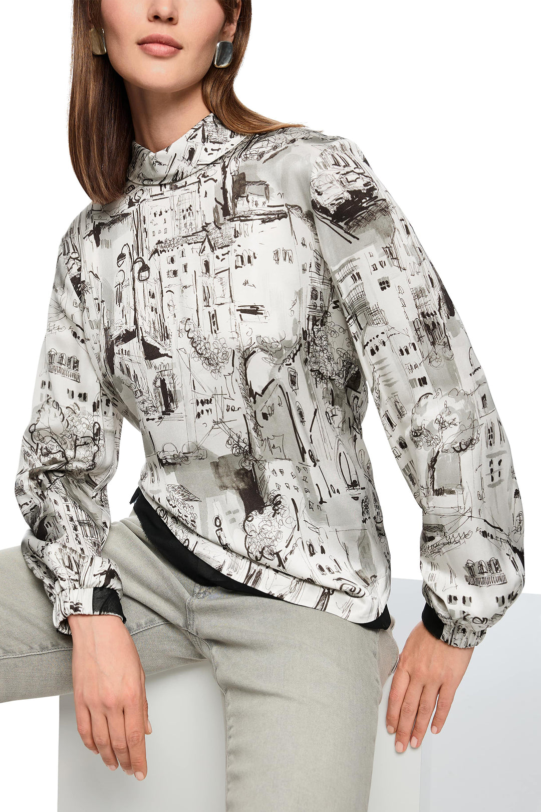Woman wearing a patterned jacket on a white background