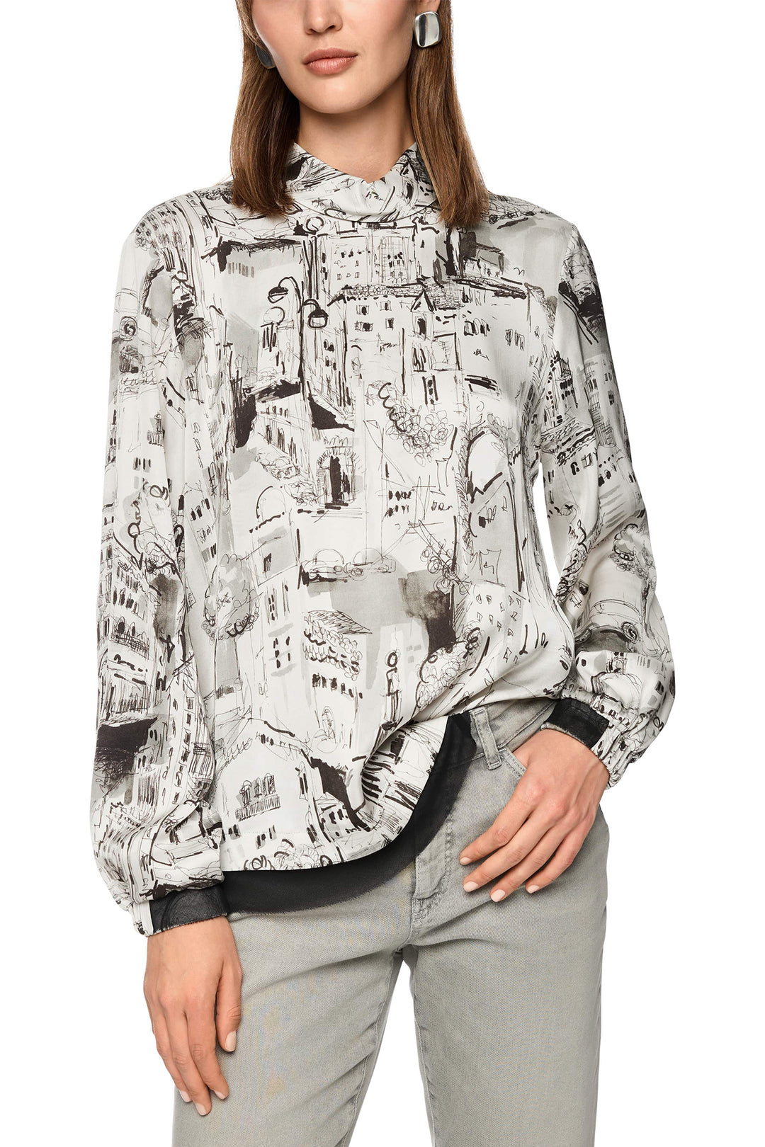 Woman wearing a patterned shirt with a white background
